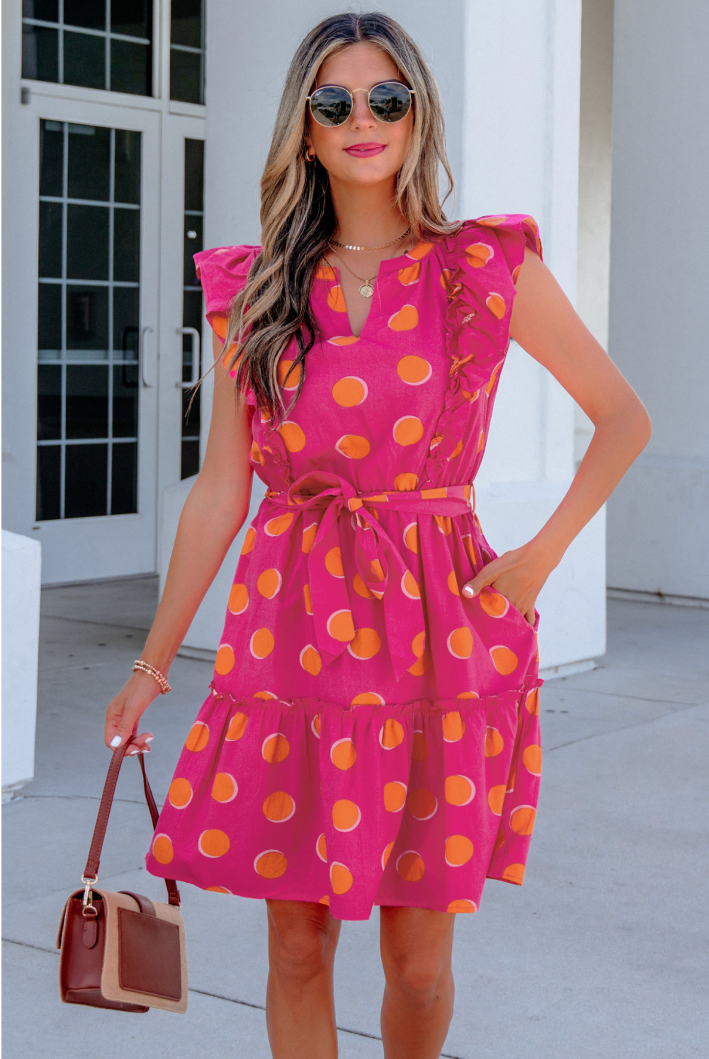 Vibrant polka dot pattern for a playful summer look. Ruffled short sleeves add a touch of elegance. Knot waist tie creates a flattering silhouette. Comfortable and breathable fabric perfect for daily wear.