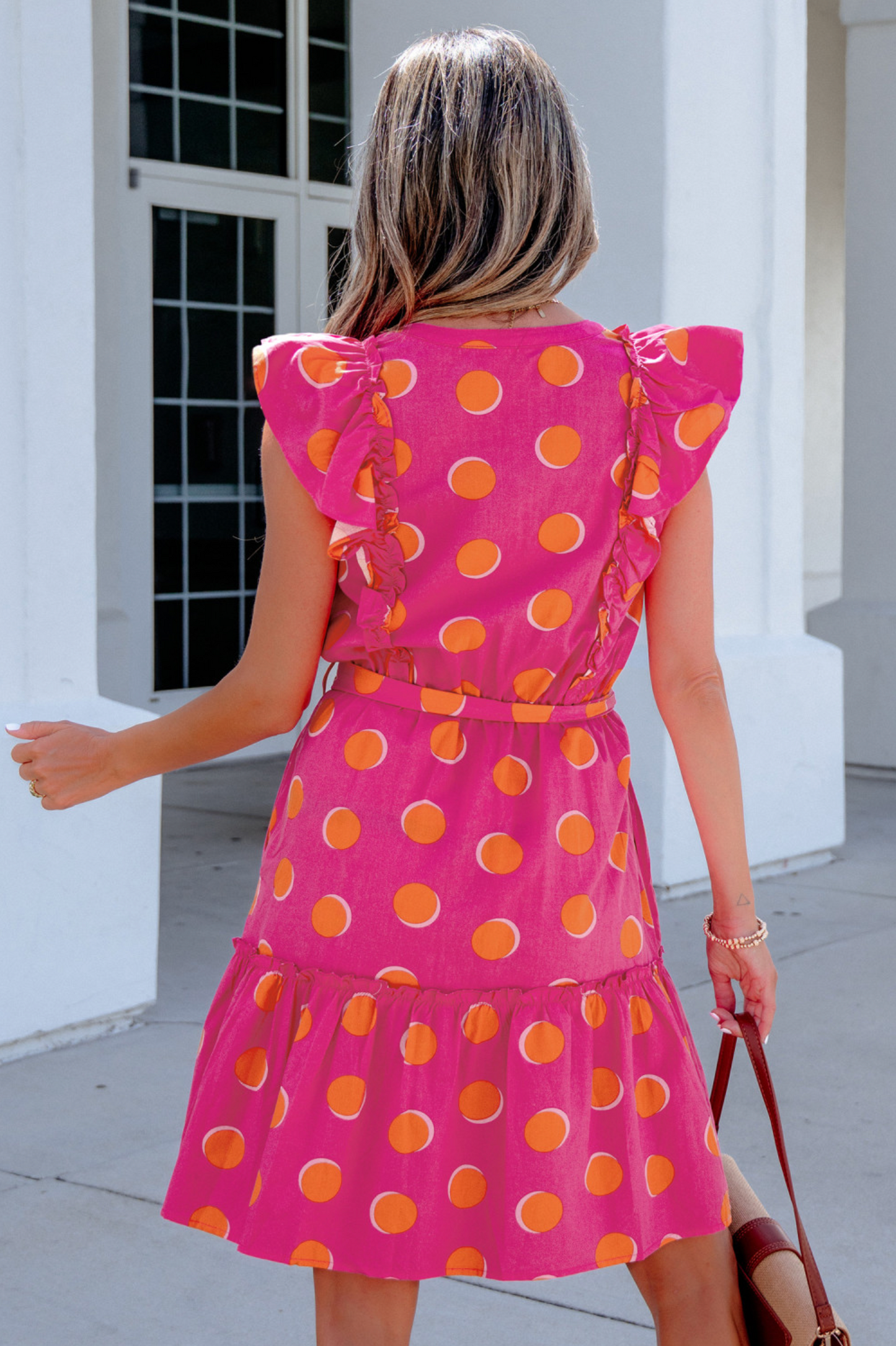 Vibrant polka dot pattern for a playful summer look. Ruffled short sleeves add a touch of elegance. Knot waist tie creates a flattering silhouette. Comfortable and breathable fabric perfect for daily wear.